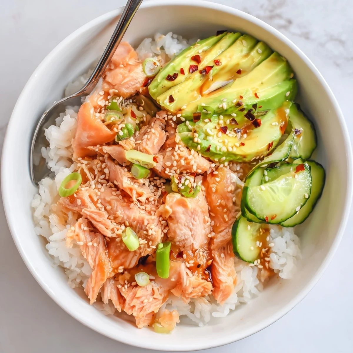 Flavorful leftover salmon and rice bowl, enhanced with vibrant pickled ginger and sesame seeds.  