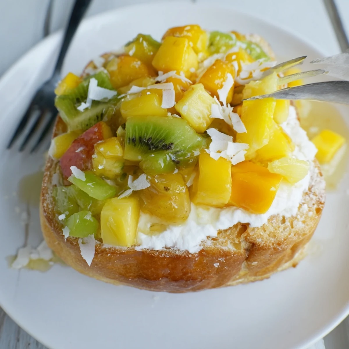 Creamy yogurt-custard toast topped with tropical fruits and shredded coconut.  