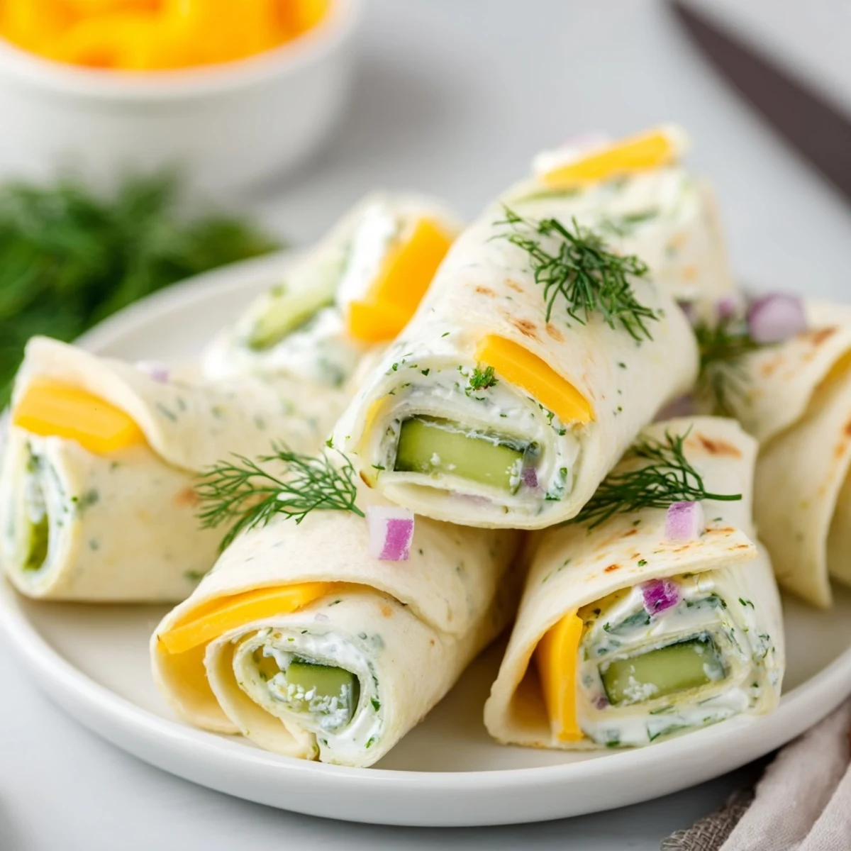 Tangy Pickle-in-a-Blanket appetizer with fresh dill and cheerful party vibes.