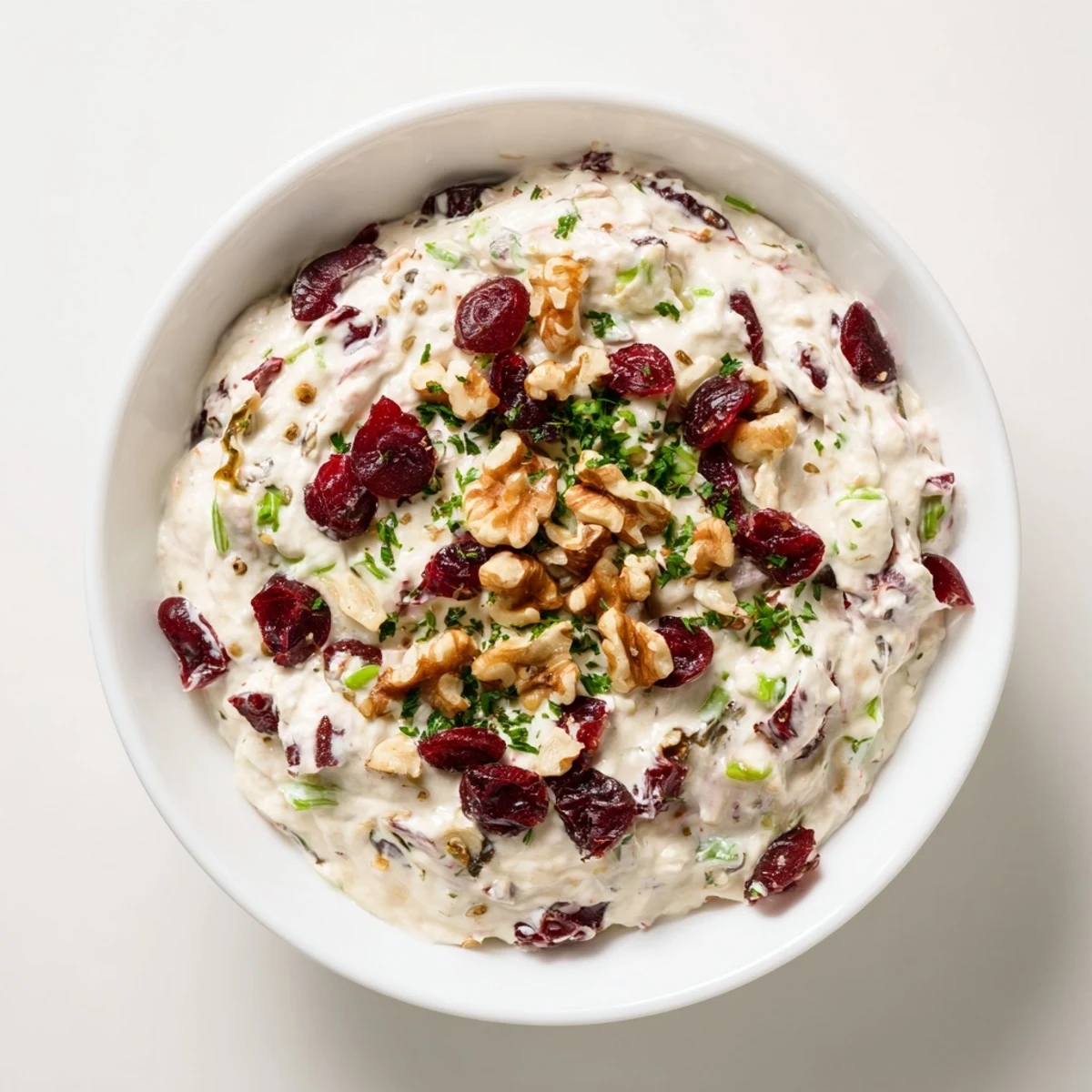 Festive Lightened Holiday Cream Cheese Dip, creamy and bursting with cranberries, ready to serve with crackers.