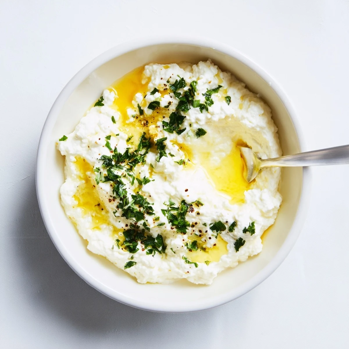 Creamy Angel Wings Whipped Feta Dip, drizzled with honey, ready to serve with crispy pita chips.