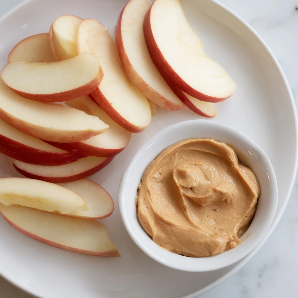 Fresh, crisp apple slices ready to be dipped into a creamy peanut butter dip.