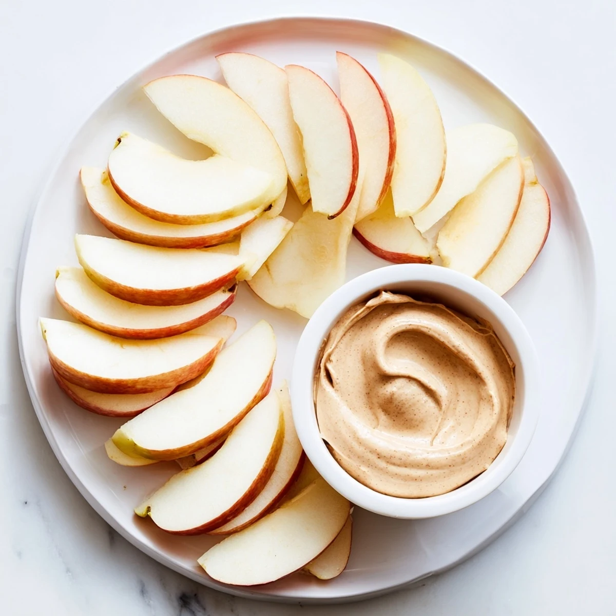Enjoy sweet apple slices with irresistible peanut butter dip, a perfect gluten-free treat.