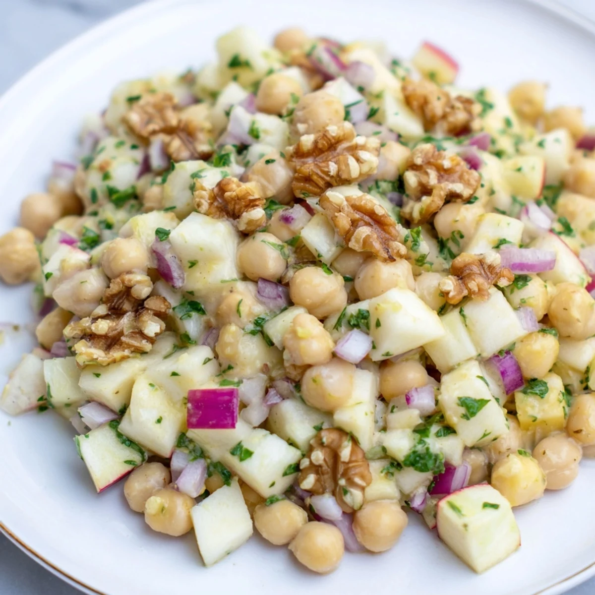 Fresh Fall Harvest Apple and Chickpea Salad: Close-up on the vibrant autumn flavors, ready to eat alongside a meal.