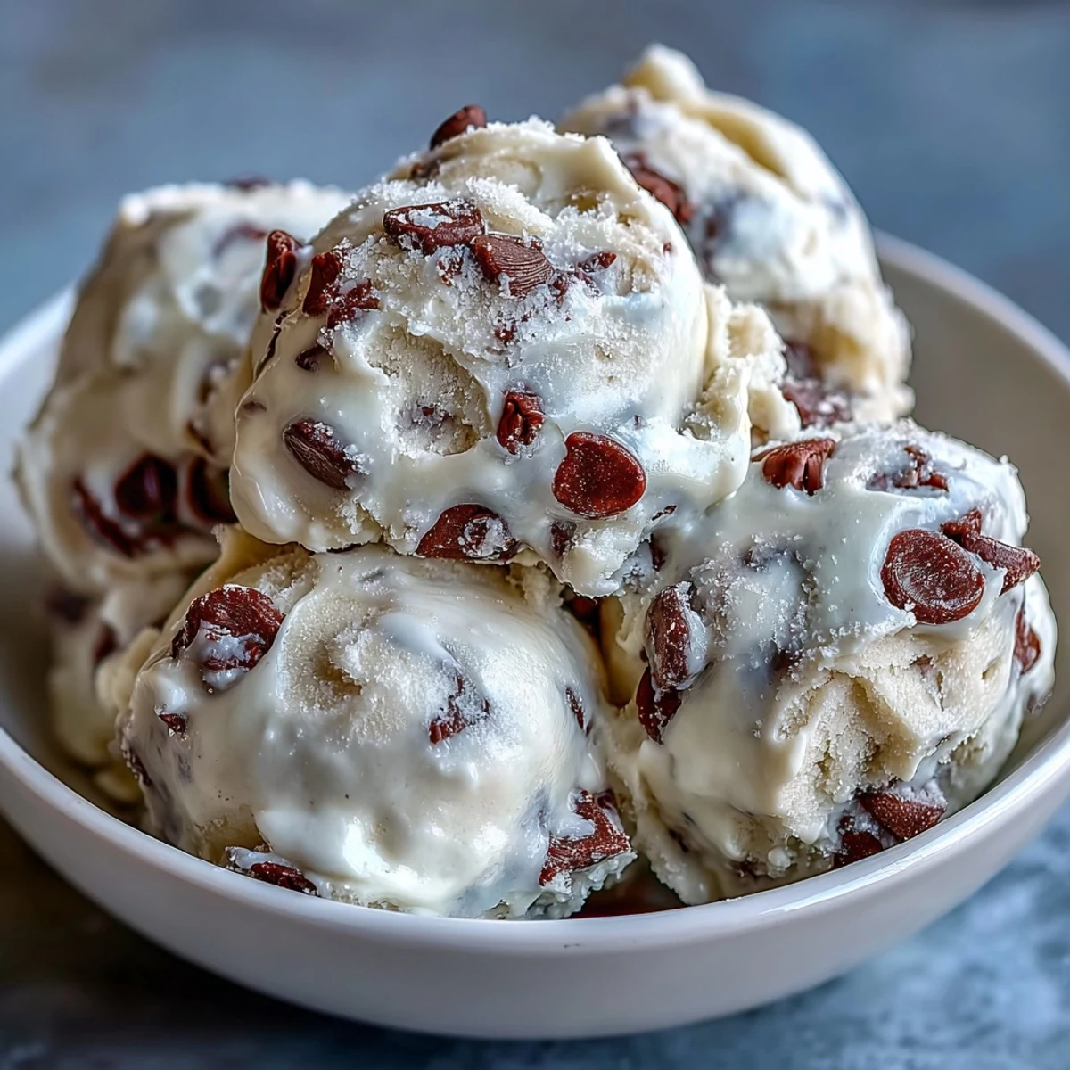Served in glass jars, Greek Yogurt Cookie Dough features creamy layers and melty chocolate chips for dessert.