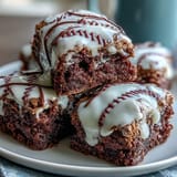 Baseball-themed brownie bites with white icing laces, rich and fudgy mini desserts for sports celebrations.  