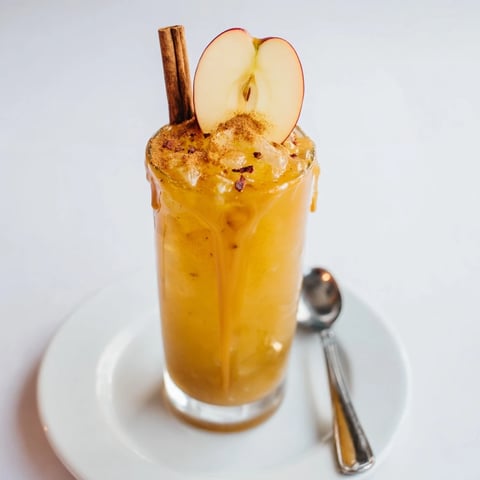 Crisp and refreshing Spicy Caramel Apple Mule garnished with cinnamon sticks and apple slices.