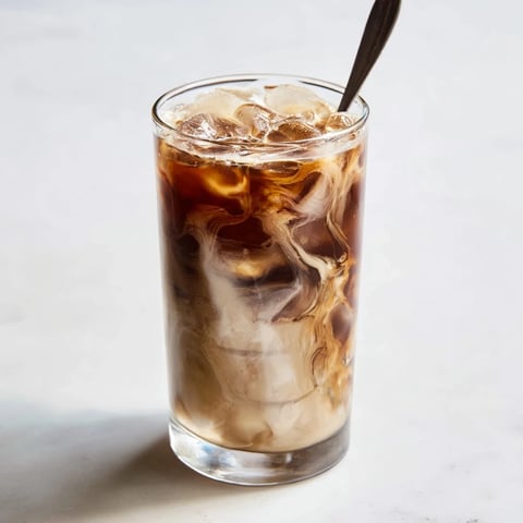 Smooth tahini iced coffee served in tall glasses with ice cubes.  
