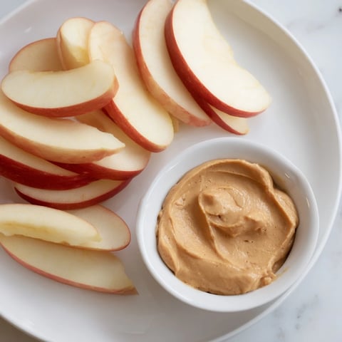Fresh, crisp apple slices ready to be dipped into a creamy peanut butter dip.