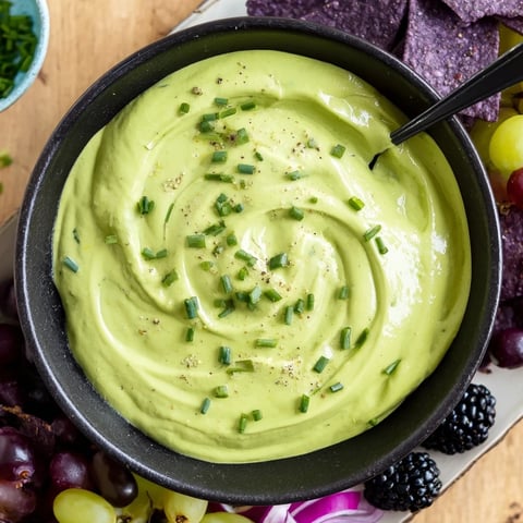 Vibrant photo of Witch's Brew Cauldron dip with dark ingredients like grapes and olives for Halloween appetizers.