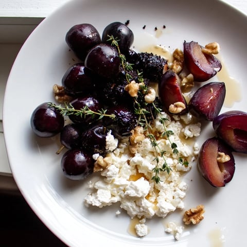 Midnight Orchard fruit and cheese platter with glistening dark cherries and creamy goat cheese.
