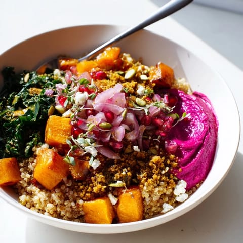 Delicious winter bowl featuring sweet potatoes, caramelized onions, and crunchy pistachio topping.  