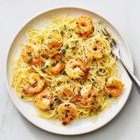 Golden shrimp nestle in flavorful lemon garlic sauce in this stunning one-skillet pasta.