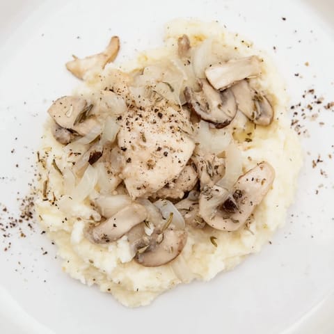 Elegant white Ghostly Gala dish with flavorful sautéed mushrooms and a sprinkle of pepper.