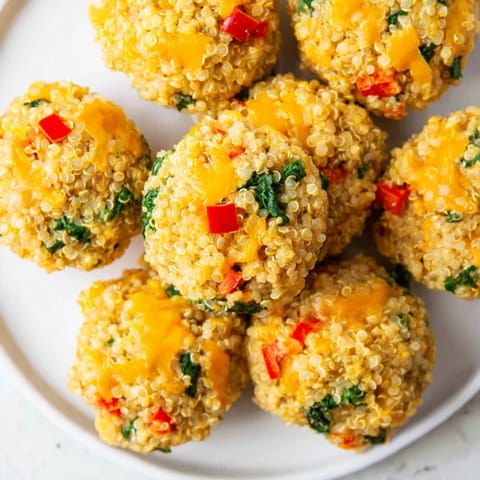 Enjoy these easy Baked Cheddar Quinoa Bites, smelling of oregano fresh from the oven, served warm.