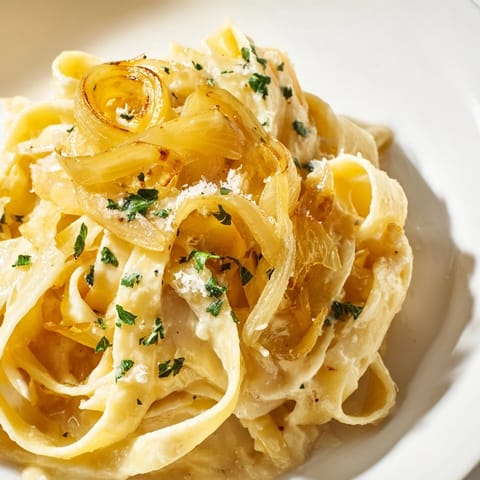 Creamy, cheesy One-Pot French Onion Pasta, a vegetarian delight, served hot and bubbling from the skillet.