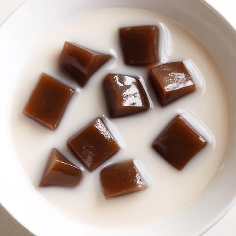 A refreshing Coffee Jelly Drink, featuring bouncy coffee cubes, a creamy dessert perfect for summer.