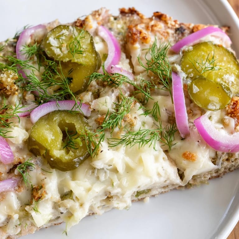 Tangy Pickle Pizza with rich crème fraîche and a bubbly mozzarella layer.