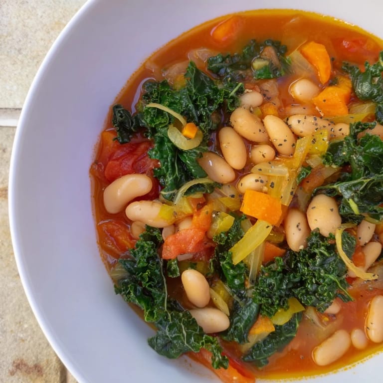 Enjoy the comforting aroma of Italian Bean & Kale Stew, perfect for a cozy, delicious dinner.