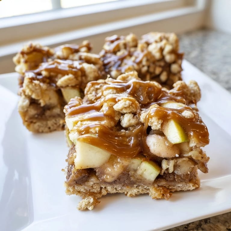 A close-up of freshly baked Caramel Apple Cookie Bars, oozing with caramel, ready to enjoy.