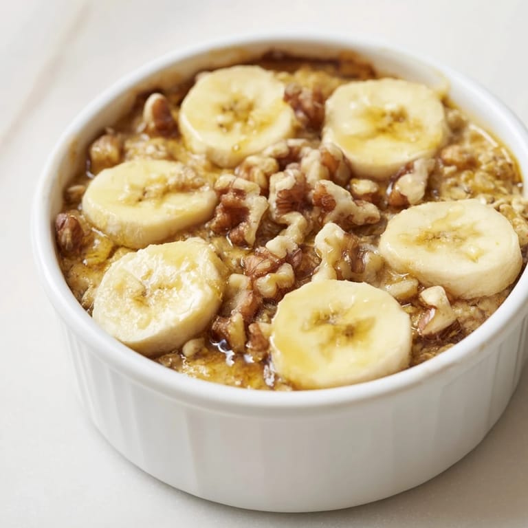 Steam rising from the Baked Oats Ramekins, showing off honey-glazed bananas for a delightful treat.