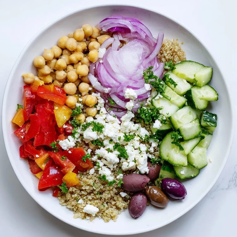 Fresh, vibrant Mediterranean Chickpea and Feta Bowl, topped with crumbled feta cheese and Kalamata olives.