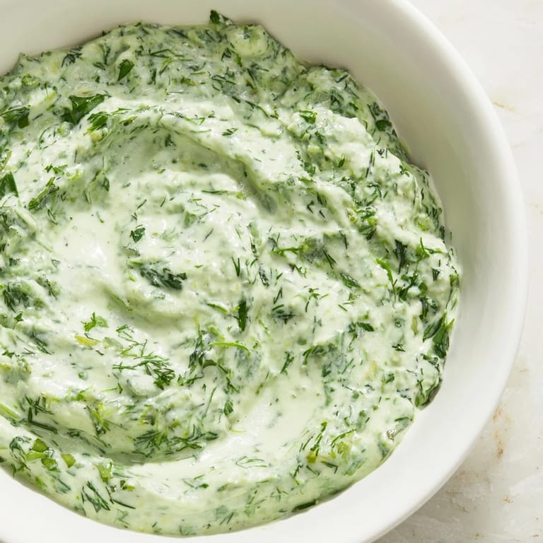 Bright green Green Goddess Dip with visible flecks of herbs, ready for dipping and spreading.