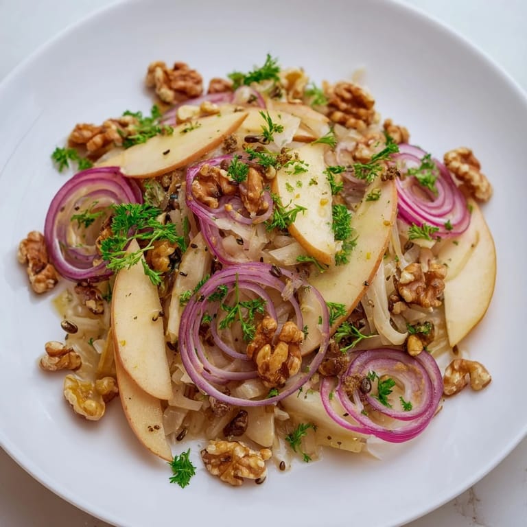 Serving suggestion for a tangy Apple and Sauerkraut Skillet Salad, plated warm with a drizzle of apple cider vinegar.