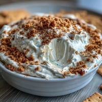Creamy cheesecake dip with graham crackers, a sweet and smooth party treat perfect for dipping.